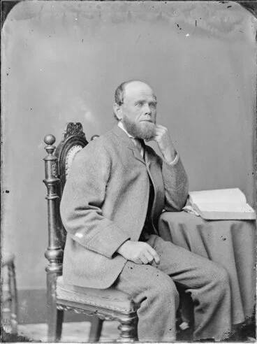 Image: Unidentified man, seated, with an open book