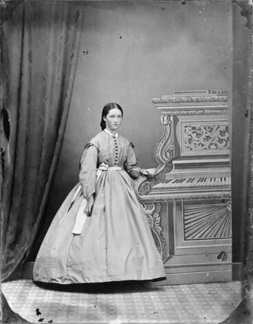 Image: Unidentified young woman with fake piano backdrop