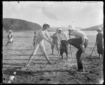 Image: Family group playing croquet on the beach