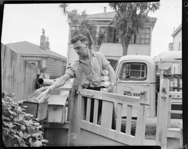 Image: Milkman delivering full bottles & collecting empties from letterbox