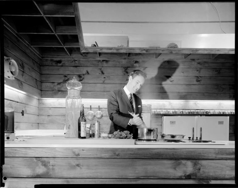 Image: [Studio?] kitchen with a man preparing food, possibly a cooking demonstration