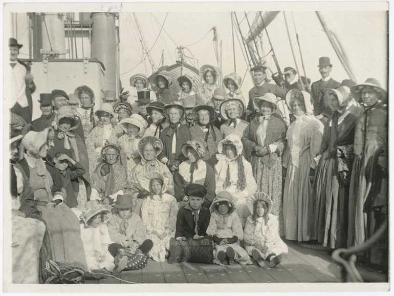 Image: Creator unknown : Photograph of a group in costume, reconstructing a scene showing settlers landing at Petone