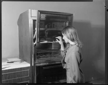 Image: Woman demonstrating Caprice wall oven
