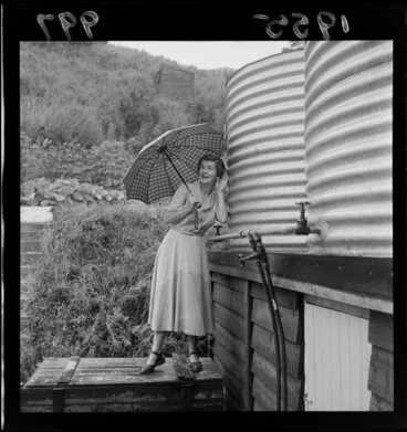 Image: Mrs Pauline Armstrong of Stokes Valley, Lower Hutt, listening to water running into her water tanks