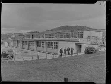 Image: Onslow College staff from left, First Assistant Principal Mr AW Morrison, Senior Mistress Miss CS Forde, Principal Mr CC Watt with an unidentiified man, outside newly constructed classrooms, Johnsonville, Wellington