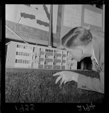 Image: Unidentified man with architectural model, at exhibition of housing schemes, Drapery and General Importing Company of New Zealand Ltd gallery