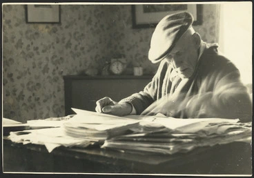Image: James Cowan at his desk, writing