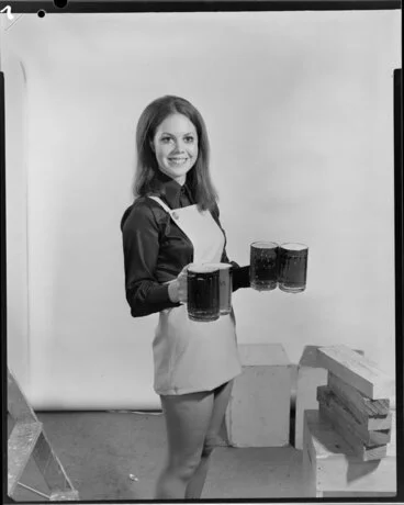 Image: Woman carrying four beer steins