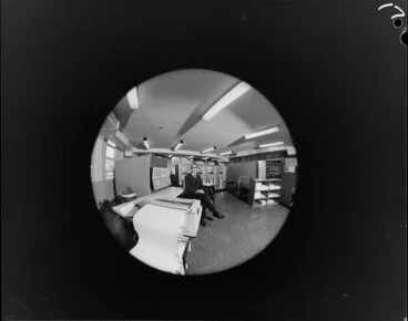 Image: Fish-eye portrait of man with computers