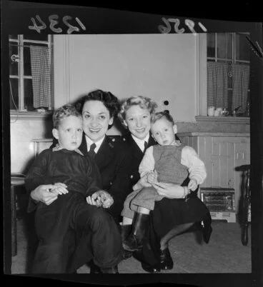 Image: Two female constables (P Mathieson and G Fullwood) with two children