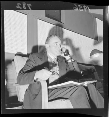 Image: Gordon Mirams on the telephone while viewing a film at the Film Censor's Office