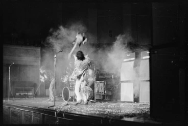 Image: Pete Townshend, throwing his guitar in the air while performing a concert with other members of The Who in Wellington