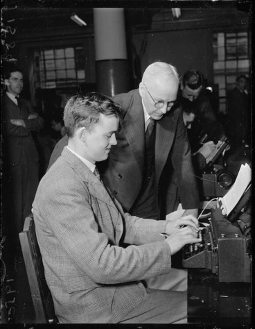 Image: Man operating teleprinter machine at a post office