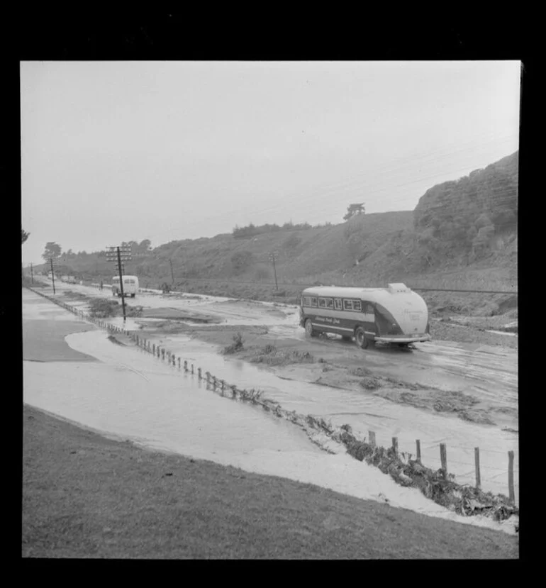 Image: Buses travelling along a flooded State Highway 1 after a washout at Te Horo, Kapiti Coast