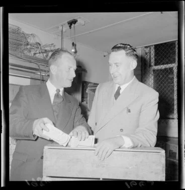 Image: Two unidentified men demonstrating how the new egg cartons can be divided in half