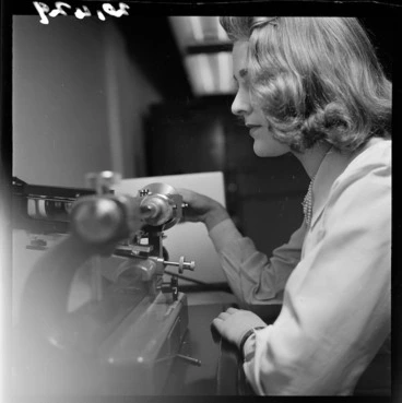 Image: Anthea Abercrombie using a machine for measuring screw gauges, Dominion Physical Laboratory, Gracefield, Lower Hutt, Wellington