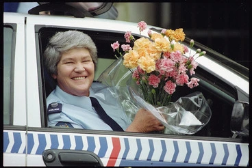 Image: Police court matron, Gail Jacobson, with flowers given to her by the Black Power gang - Photograph taken by Craig Simcox