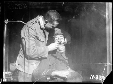 Image: A New Zealand Dental Corps dentist carrying out an inspection during World War I