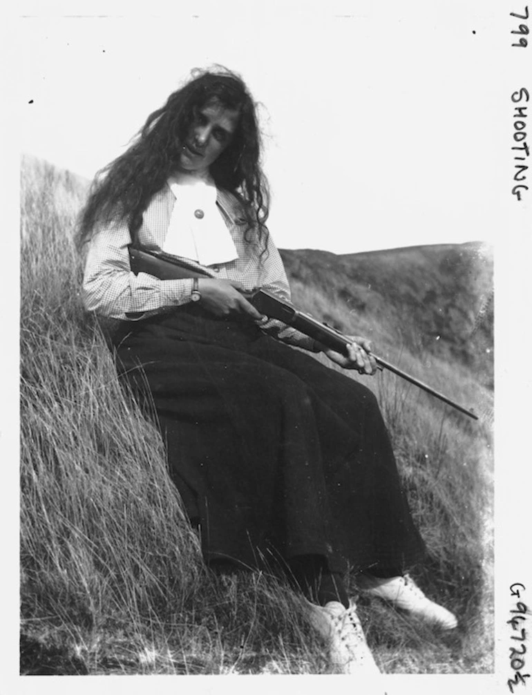 Image: Unidentified woman holding a shotgun, location unidentified