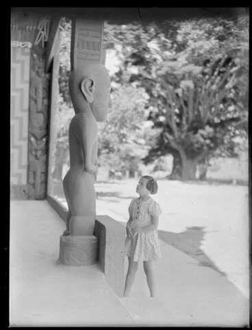 Image: Summer Child Studies series, unidentified young girl, studying a carved Maori post