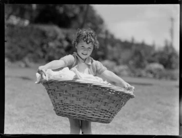 Image: Summer Child Studies series, unidentified young girl, with a laundry basket