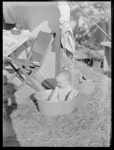 Image: Summer Child Studies series, young child in a tub on a lawn