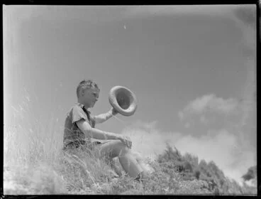 Image: Summer Child Studies series, unidentified boy, sitting and waving his hat