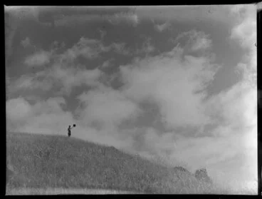 Image: Summer Child Studies series, boy, waving his hat on an hilltop
