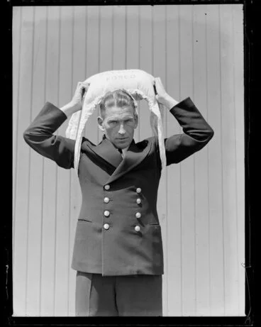Image: Tasman Empire Airways Ltd crew member demonstrating use of life jacket