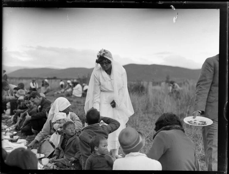 Image: Bride [Ruinea Rota], gives cake to whanau and friends at Korohe marae, Tūrangi