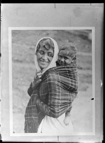 Image: Annie Ngauru Hoko (nee Downs) woman carrying a young child on her back wrapped in a blanket