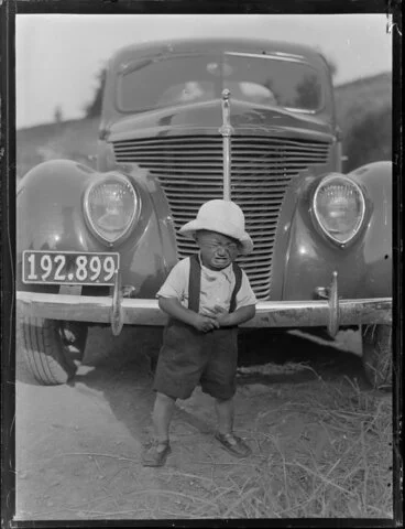 Image: Young Māori boy crying in front of a vehicle