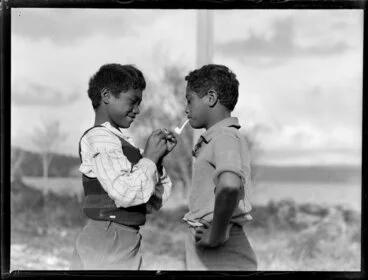 Image: Māori boy lighting the pipe for his young friend, Waikato