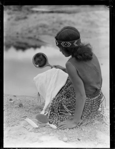 Image: A Maori woman grooming herself by the river, Waikato