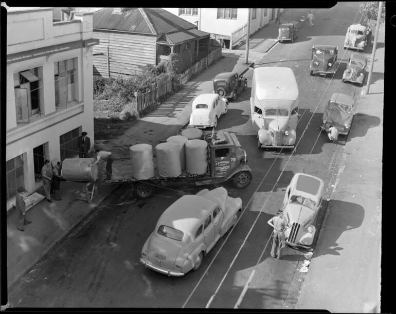 Image: Unloading bales from truck, location unidentified