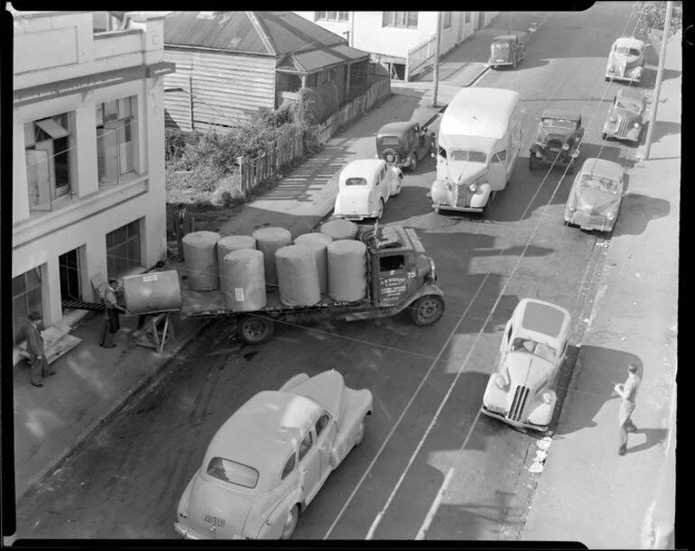 Image: Unloading bales from truck, location unidentified