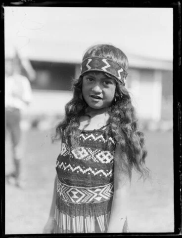 Image: Unidentified Maori girl wearing traditional kapa haka performance dress, including piupiu [Rotorua?]