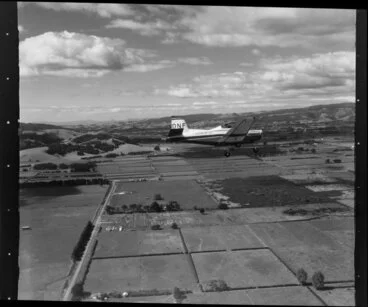 Image: Auckland Aero Club Airtourer aircraft (DNF) banking in the skies above farmland in the Auckland area