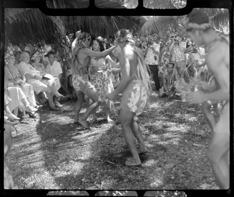 Image: Unidentified local dancers, possibly including Augustine, perform the hula at a ceremony feast, Tahiti