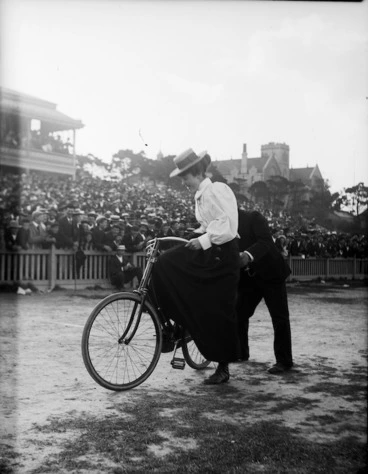 Image: Female competitor in a cycle race, being assisted by a starter