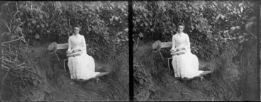 Image: Lydia Myrtle Williams reading book on bench in garden, location unidentified