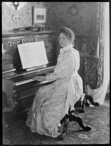 Image: Nellie Devereux playing piano, location unknown