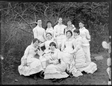 Image: Unidentified group of young women dressed in white and posing under a tree