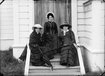 Image: The Devereux sisters, Margaret Ellen (Nellie), Lydia Myrtle, and Marian Amy, on the back steps of their family home, Lower Hutt, Wellington Region