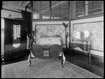 Image: Double bedroom suite scene, with dresser with mirror, wardrobe with mirror and plants on plant stands