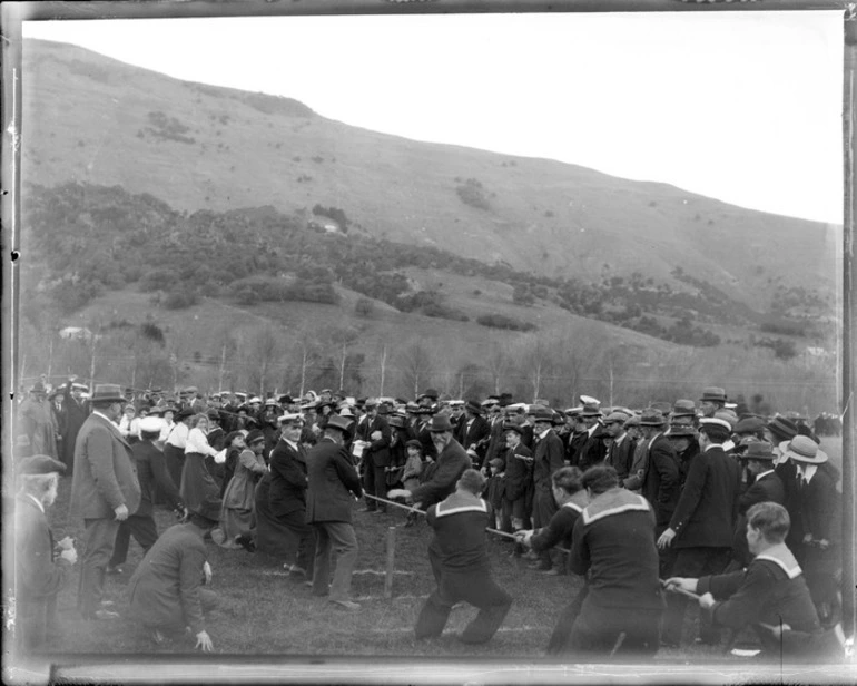 Image: Little River, Wairewa County, Canterbury, showing a tug of war team involving a group of men and women, crowds of people watching