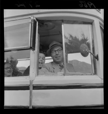 Image: An unidentified man [bus driver? teacher?] with an unidentified pupil from Ngaio School, Wellington, looking out of a bus on a trip to Matamata