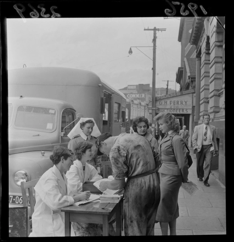 Image: Blood donation staff talking to members of the public, on an unidentified street, Wellington