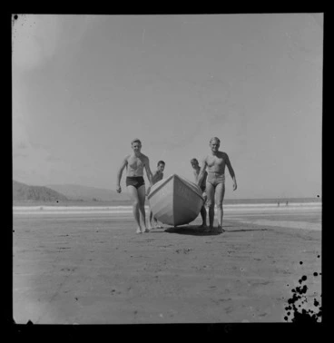 Image: Unidentified surf lifesavers carrying surf boat Vanj at the 1957 National Surf Life Saving Championships, Lyall Bay, Wellington