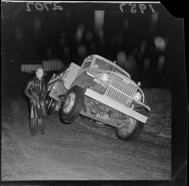 Image: Truck stuck in mud on Wainuiomata Hill and an unidentified man next to the truck, Lower Hutt